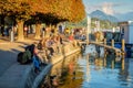 People enjoy sunset at the shore of Lake Lucerne, Switzerland